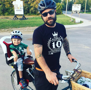 father and son on bicycle with child seat